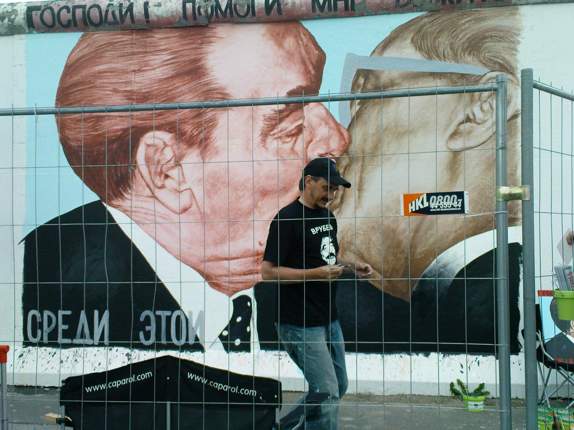 Dmitry Vrubel repainting the Bruderkuss mural at the East Side Gallery in 2009